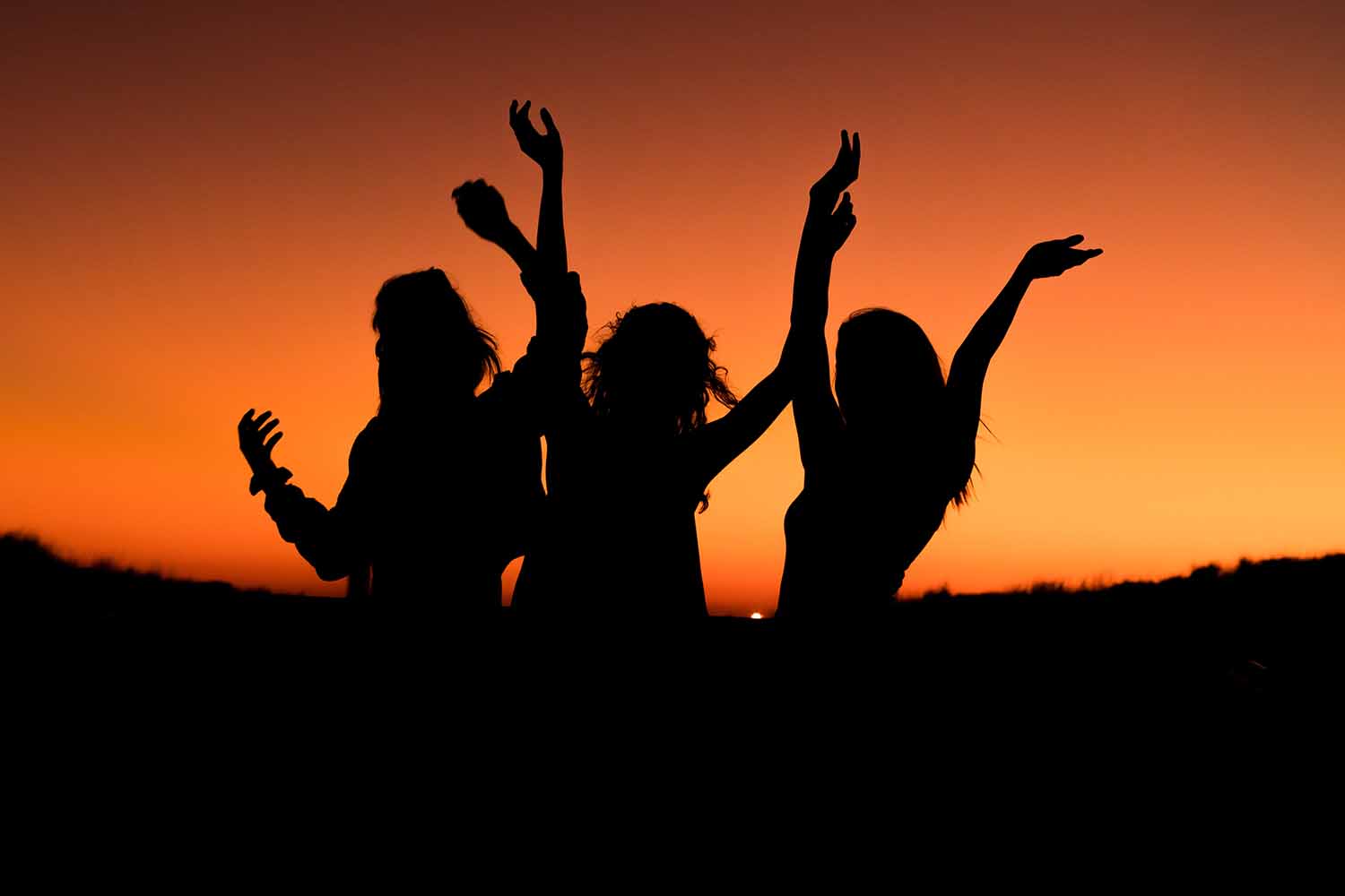 Group of people in front of sunset